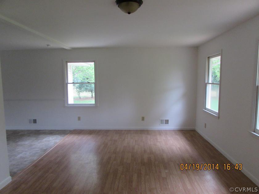 2958 Briery Road Keysville, VA 23947 - Photo 6 of 9 an empty room with wooden floor and windows