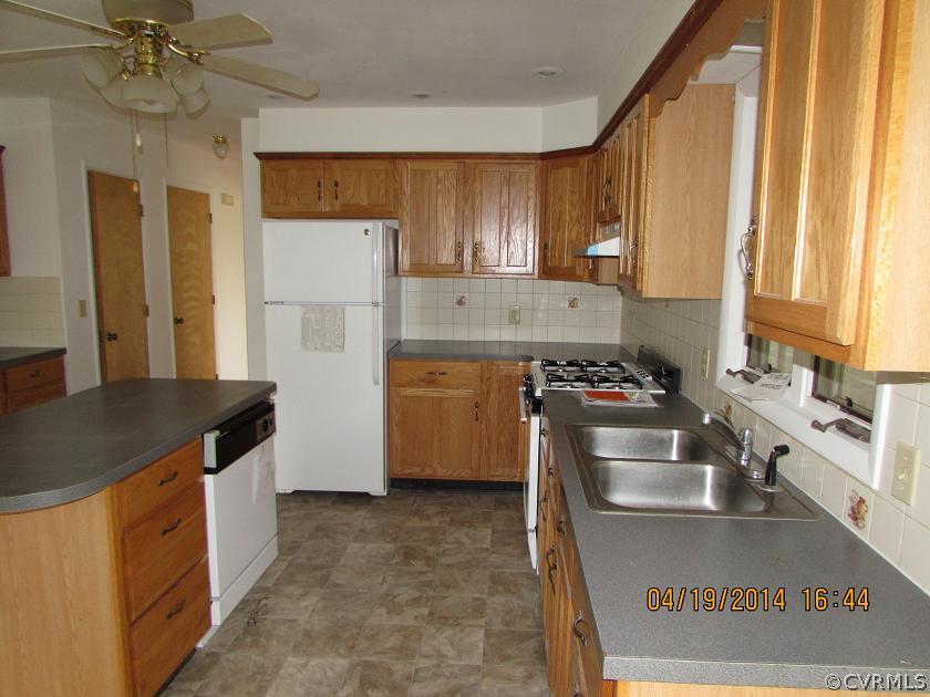 2958 Briery Road Keysville, VA 23947 - Photo 7 of 9 a kitchen with stainless steel appliances granite countertop a sink a stove and a refrigerator