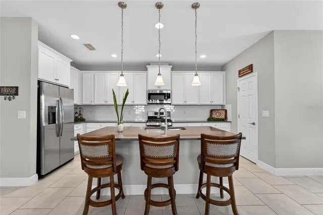 a bathroom with a granite countertop double vanity sink and mirror