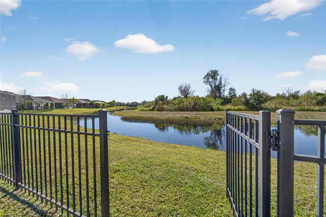 a view of a dining room and livingroom with furniture wooden floor a chandelier