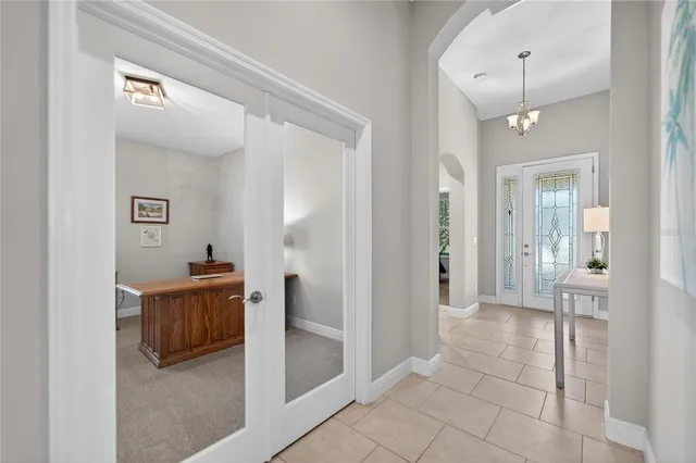 a bathroom with a granite countertop sink a potted plant and a mirror