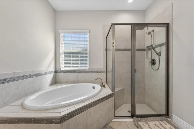 an aerial view of residential houses with outdoor space and lake view