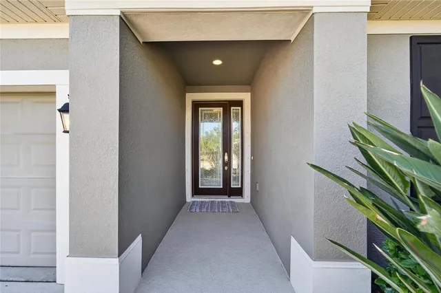a kitchen with stainless steel appliances kitchen island a chandelier and refrigerator