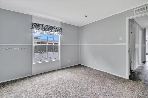 a view of an empty room with a window