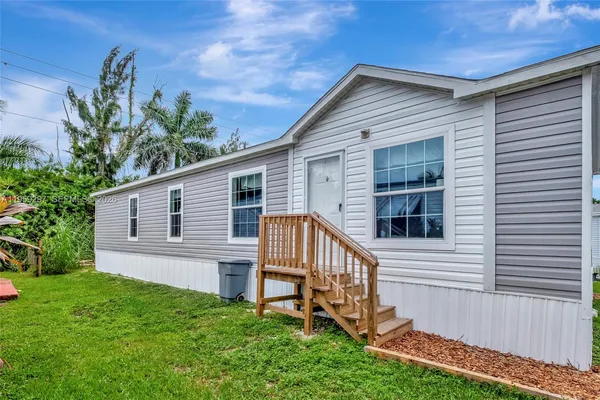 a view of backyard with a garden and deck