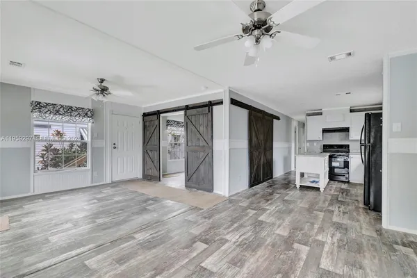 a view of a kitchen with a sink and a refrigerator