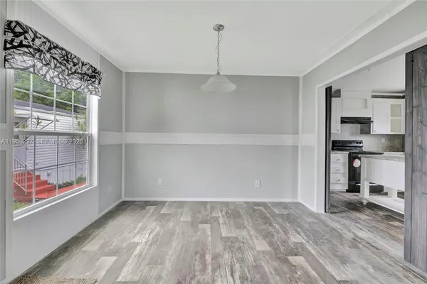 a view of kitchen with refrigerator and window
