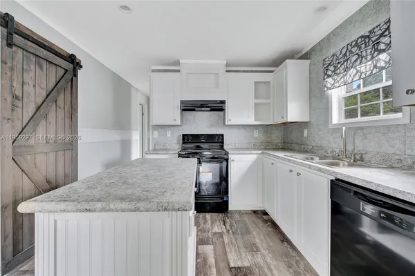 a kitchen with a sink stove and cabinets