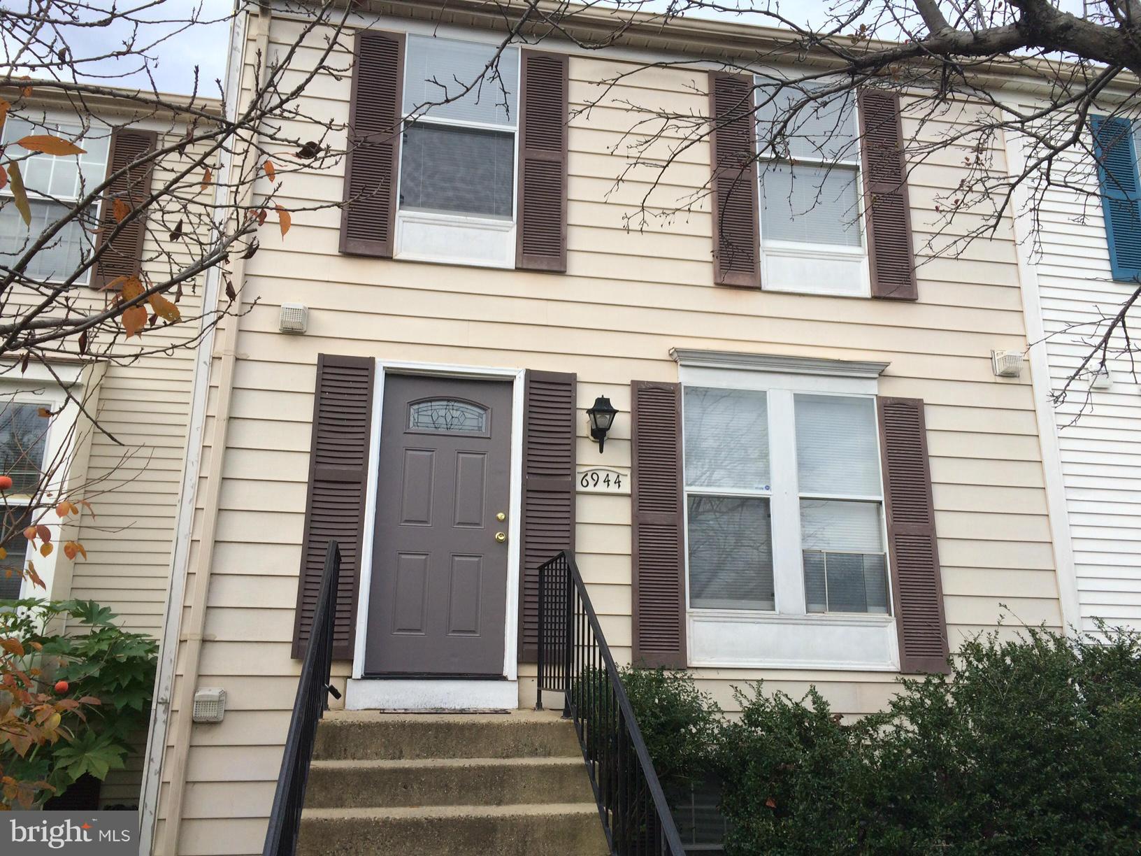 6944 Villa-Del-Rey Court Springfield, VA 22150 - Photo 1 of 14 a front view of a house with a window and garage