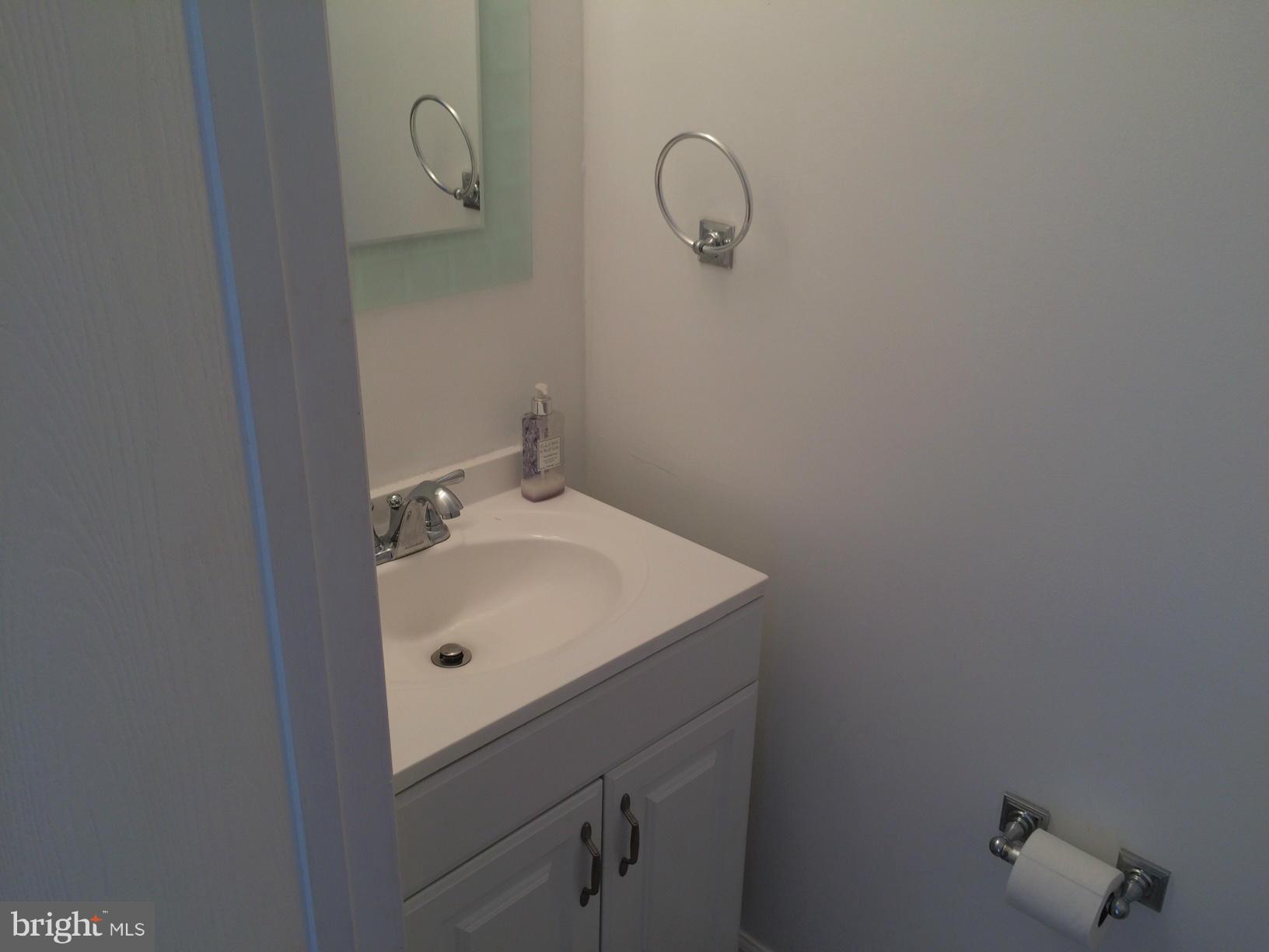 6944 Villa-Del-Rey Court Springfield, VA 22150 - Photo 11 of 14 a bathroom with a sink and mirror