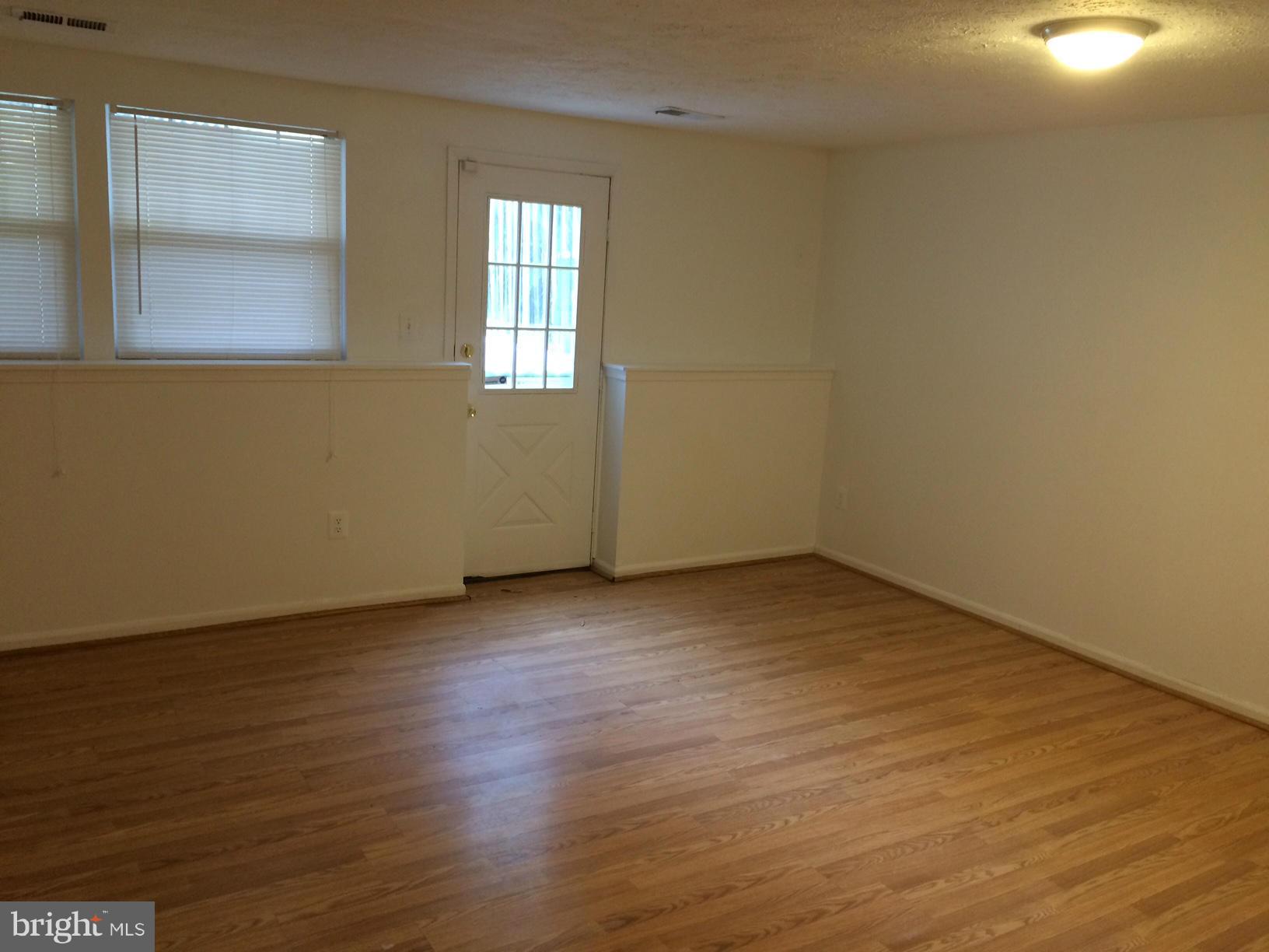 6944 Villa-Del-Rey Court Springfield, VA 22150 - Photo 13 of 14 an empty room with wooden floor and windows
