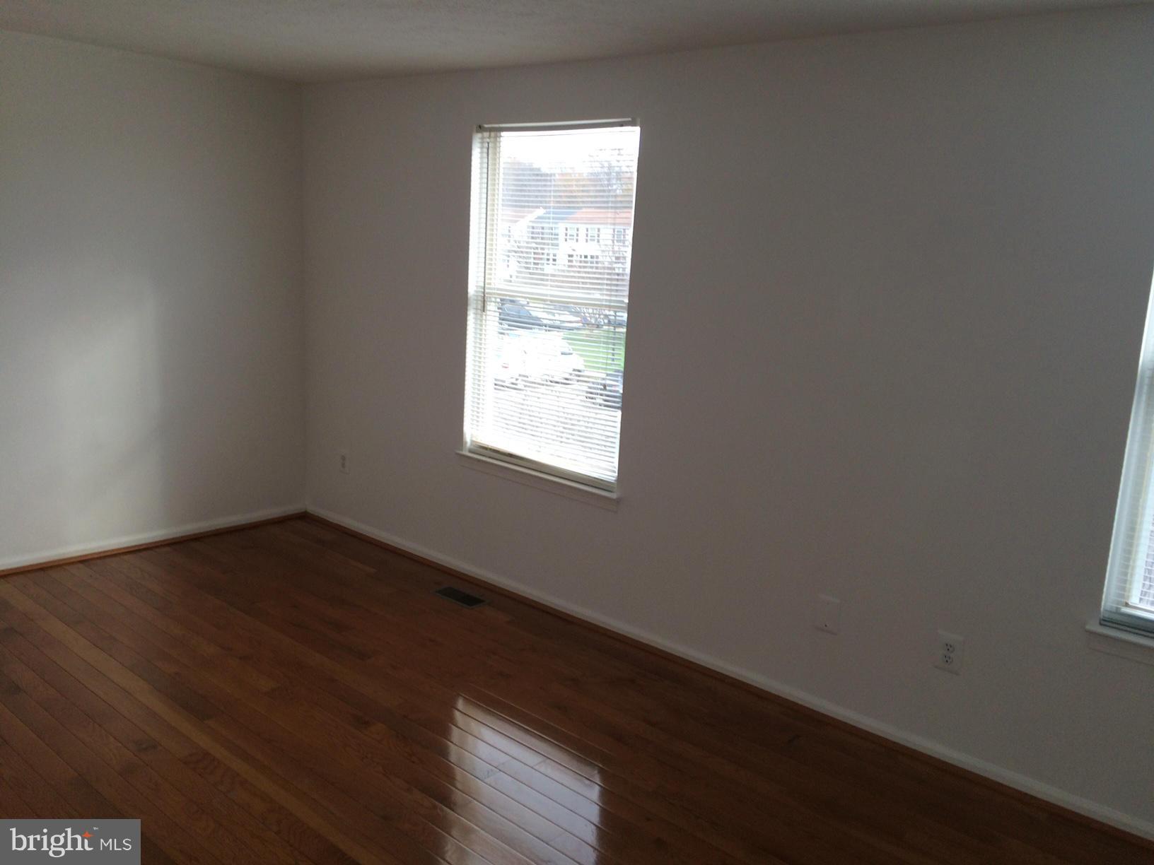 6944 Villa-Del-Rey Court Springfield, VA 22150 - Photo 7 of 14 an empty room with wooden floor and windows
