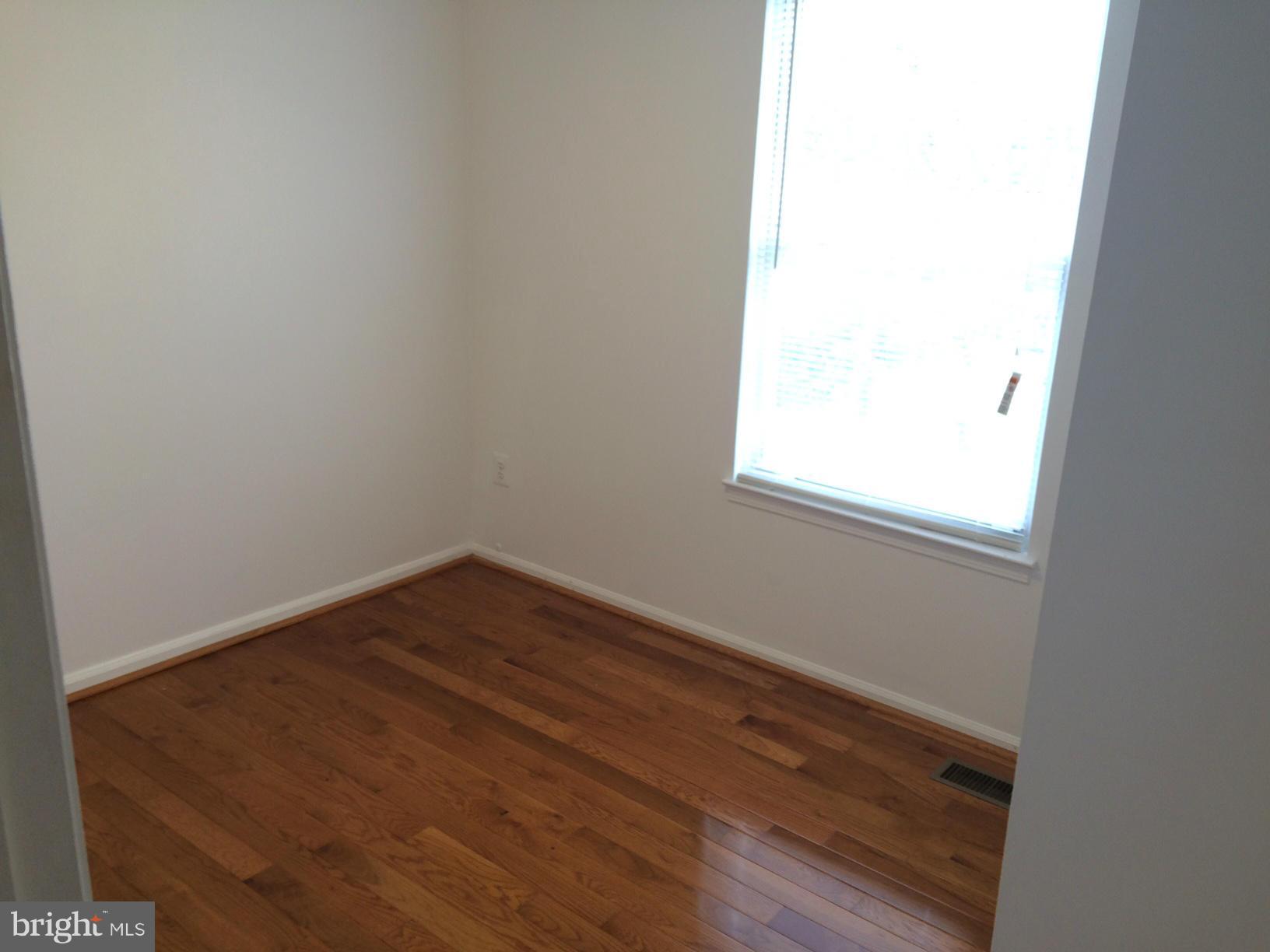 6944 Villa-Del-Rey Court Springfield, VA 22150 - Photo 8 of 14 a view of a small space with wooden floor and a window