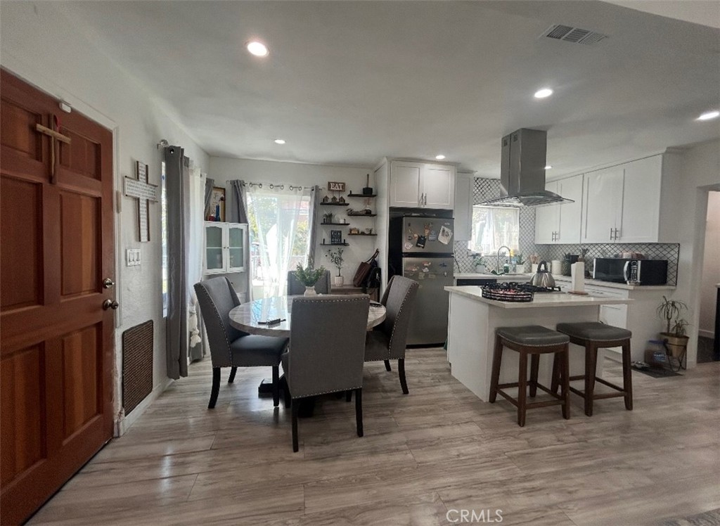 1715 West 155th Street Compton, CA 90220 - Photo 4 of 7 a dining room with furniture and wooden floor