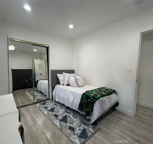 a bedroom with a bed and a mirror