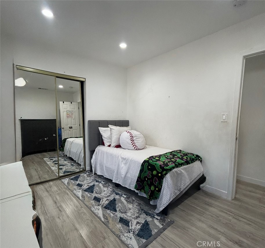 1715 West 155th Street Compton, CA 90220 - Photo 5 of 7 a bedroom with a bed and a mirror
