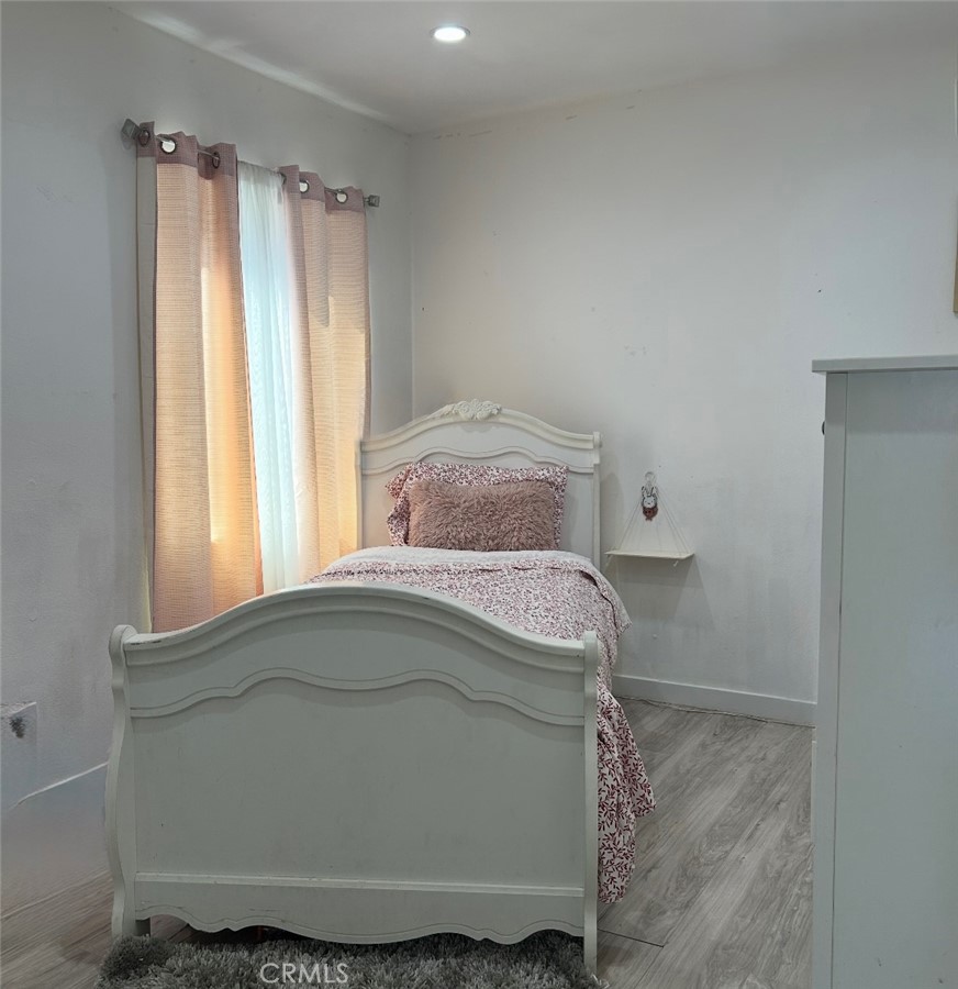 1715 West 155th Street Compton, CA 90220 - Photo 6 of 7 a bedroom with a bed and a window
