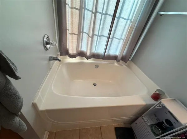 walk in closet with clothes and shoes