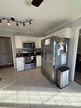 a kitchen with refrigerator and car parked