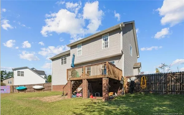 a view of garden with wooden fence