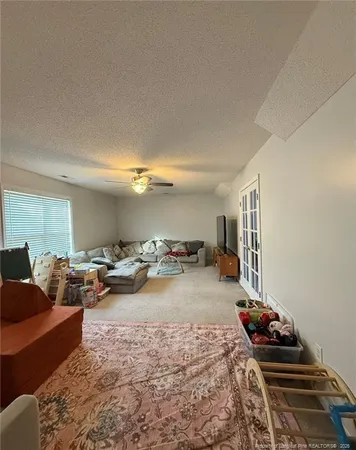 a living room with furniture and a chandelier