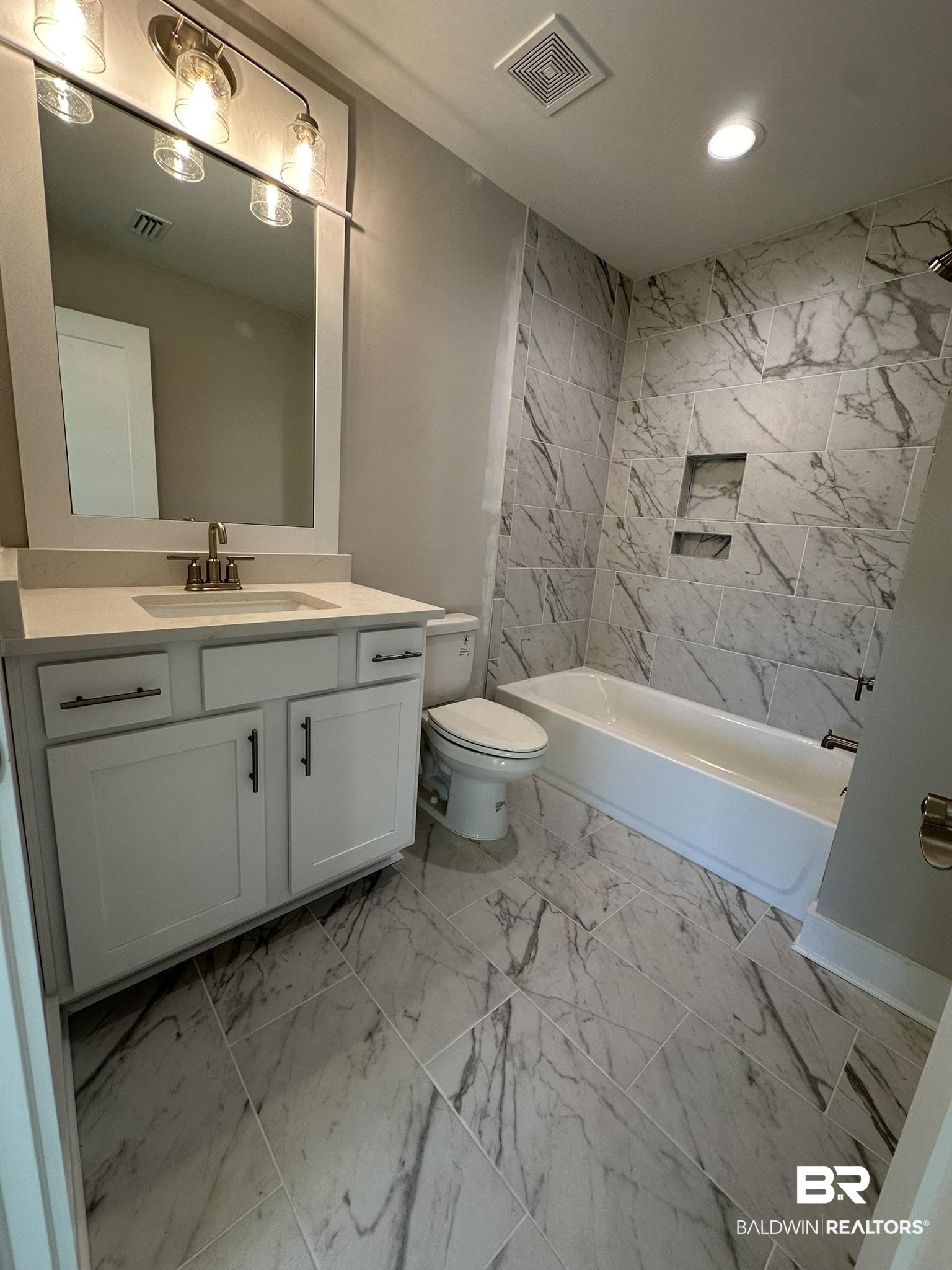 23582 Travis Stock Street, Unit 48 Foley, AL 36535 - Photo 30 of 51 Full bathroom featuring vanity, toilet, and tiled shower / bath