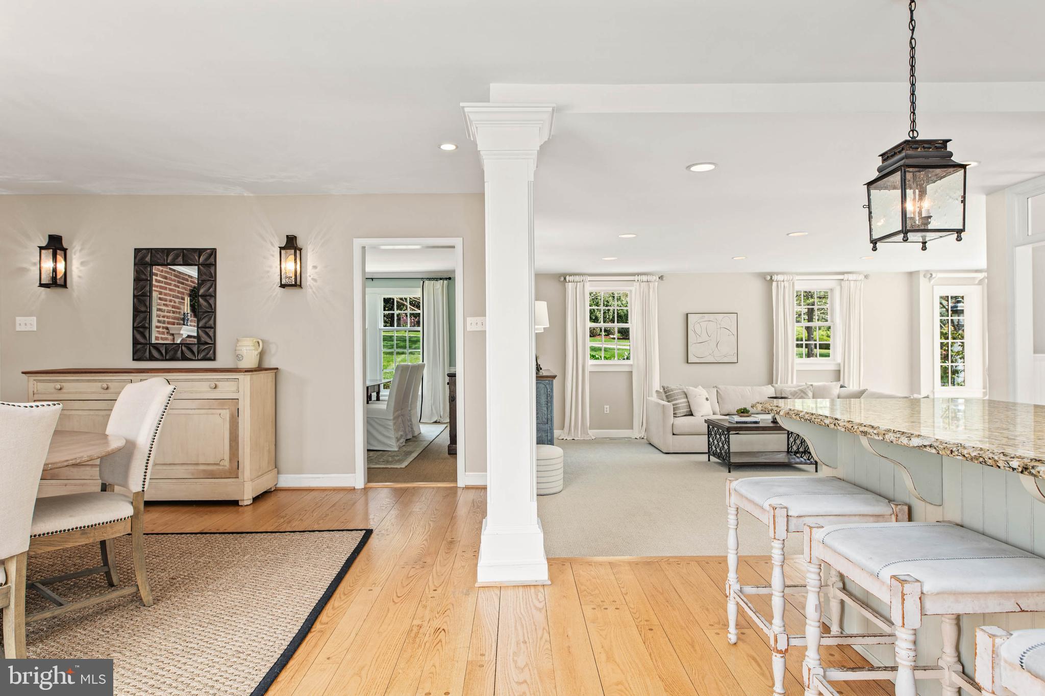 8 Rabbit Run Road Malvern, PA 19355 - Photo 17 of 49 a living room with furniture a wooden floor and a chandelier