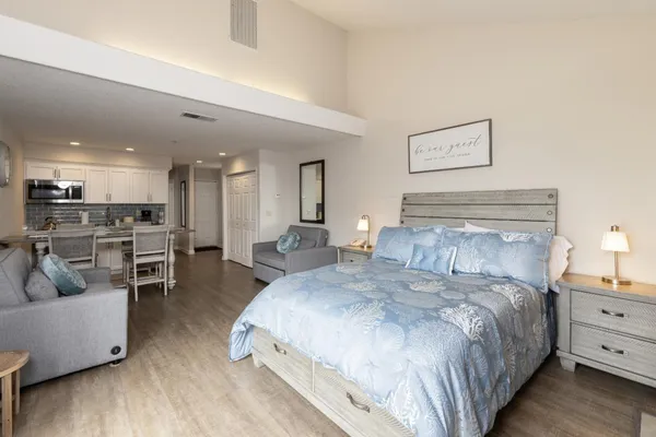 a spacious bedroom with a bed and a couch