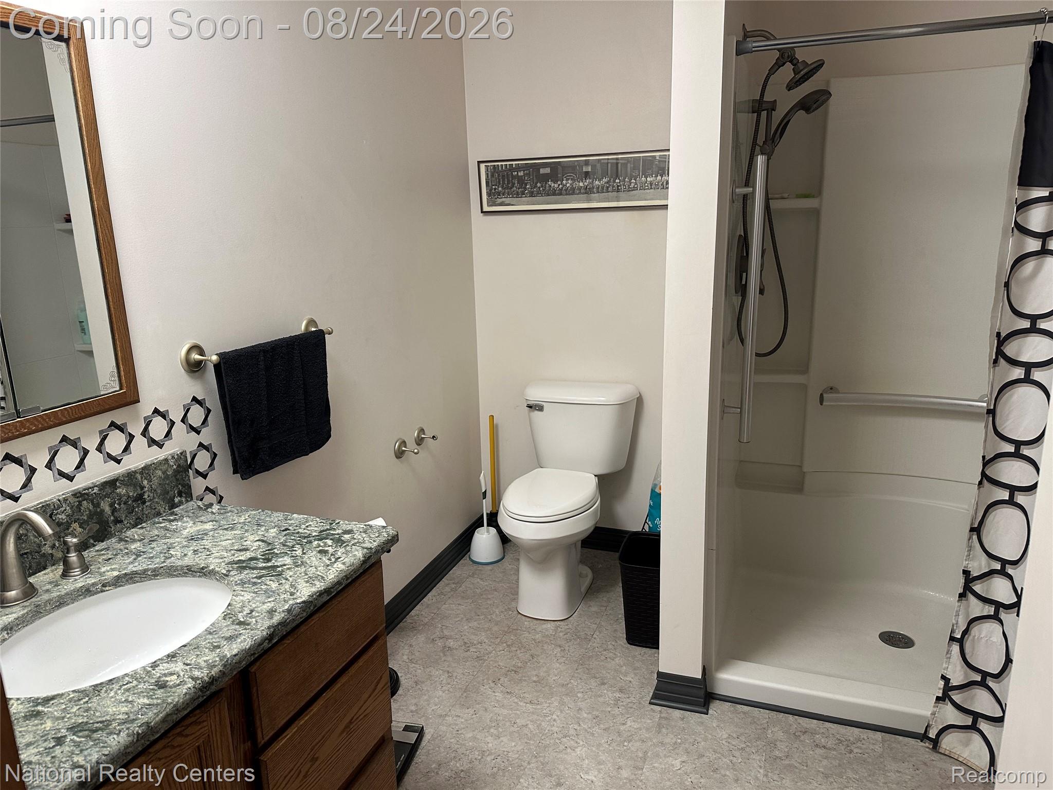 968 Tyrrell Road Bancroft, MI 48414 - Photo 16 of 24 Vanity with an integrated sink, brushed nickel faucet, and natural stone countertop