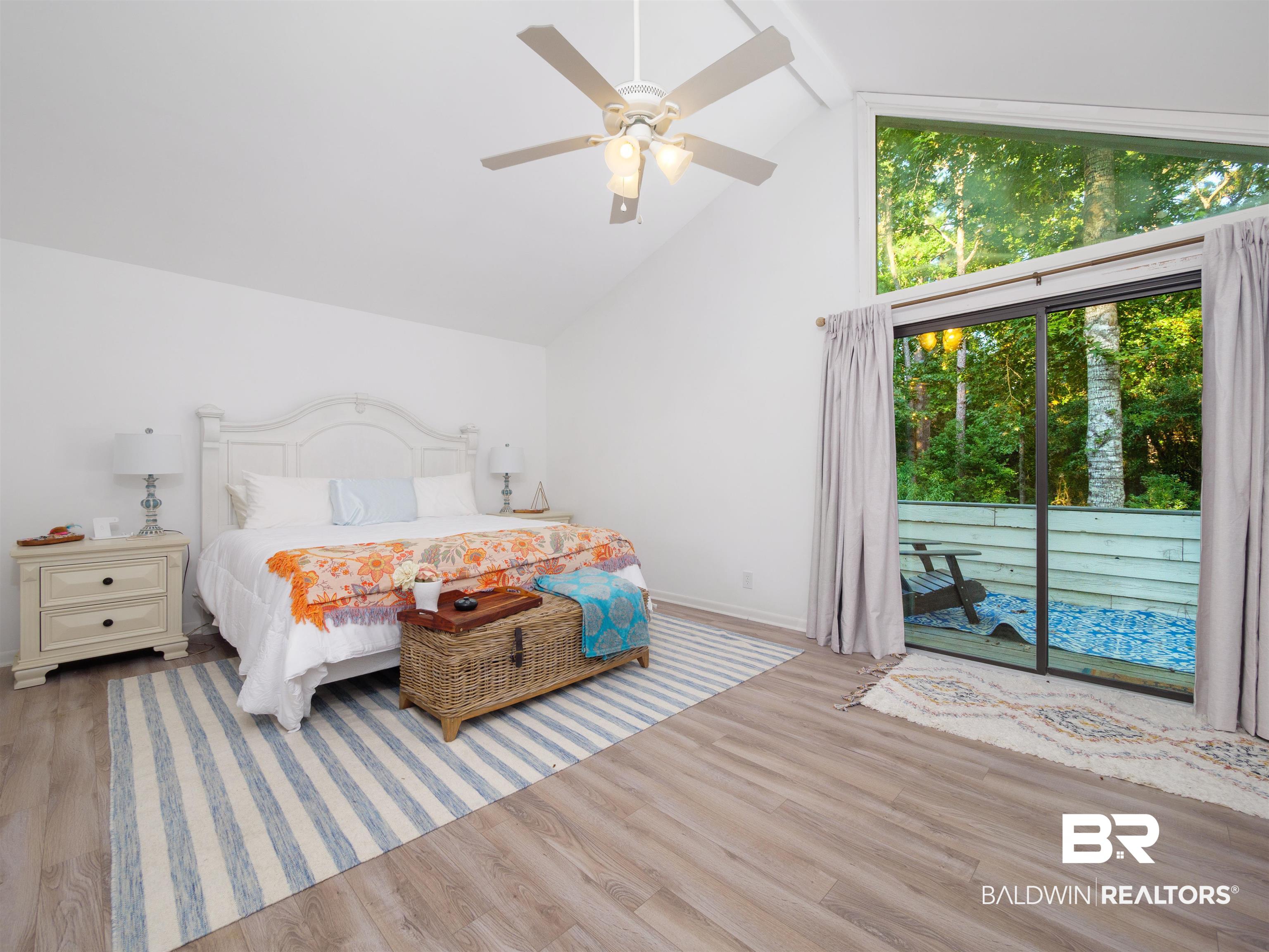 494 Ridgewood Drive Daphne, AL 36526 - Photo 24 of 40 Bedroom featuring light hardwood / wood-style floors, access to outside, beam ceiling, high vaulted ceiling, and ceiling fan