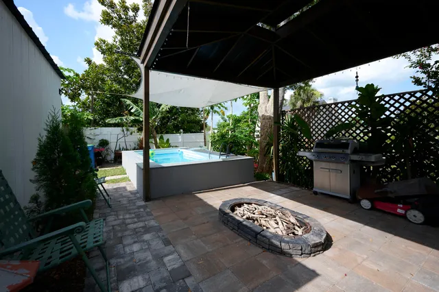 a view of a porch with furniture and garden