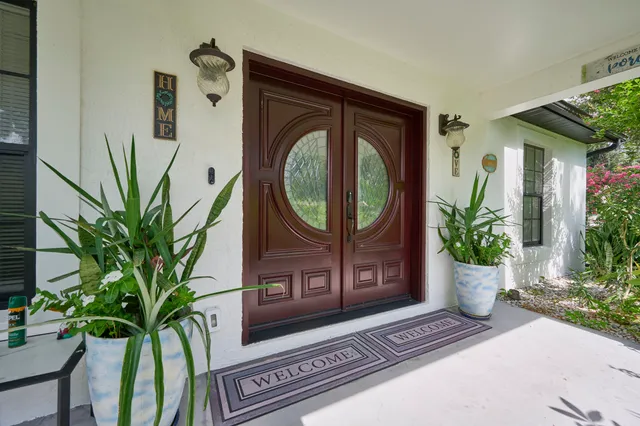 a view of house with swimming pool and outdoor seating