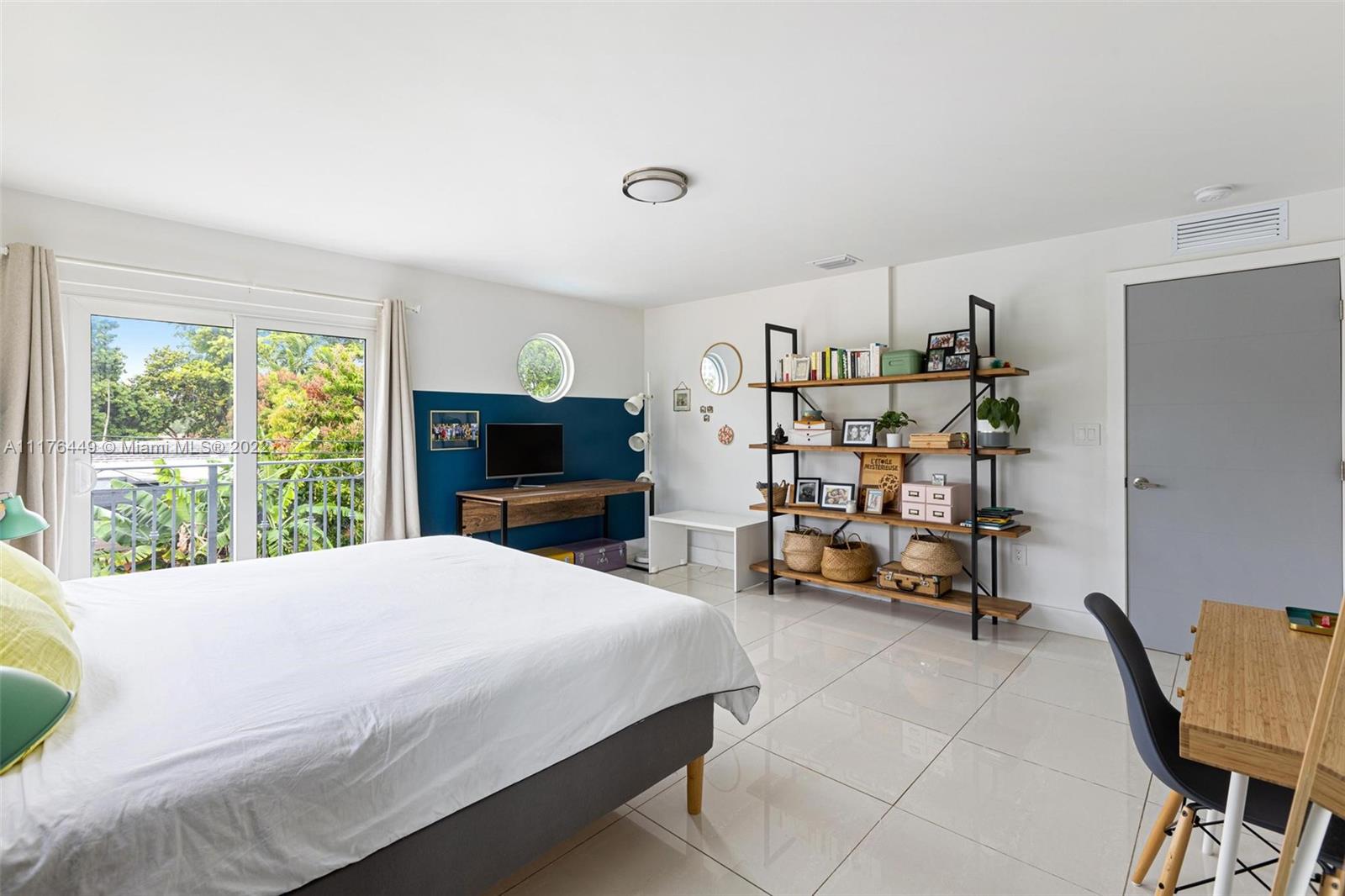 1910 Coral Gate Drive Miami, FL 33145 - Photo 15 of 39 a bedroom with a bed a table and a large window