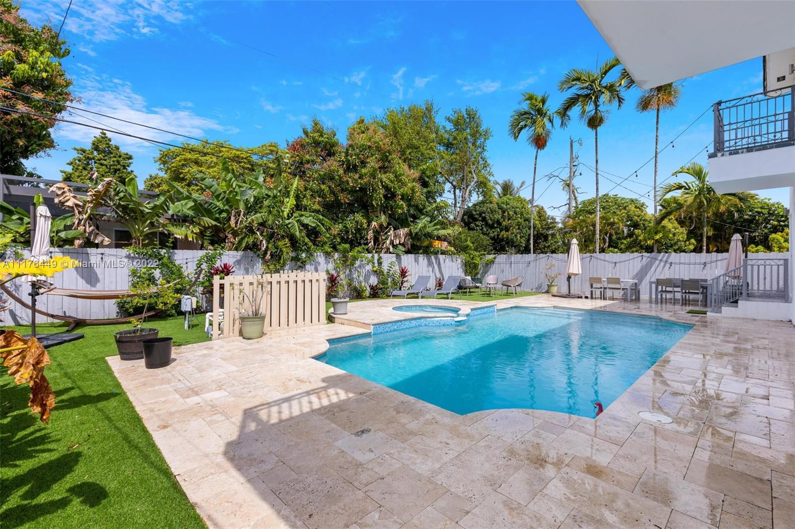 1910 Coral Gate Drive Miami, FL 33145 - Photo 2 of 39 a view of a swimming pool with a patio and a yard