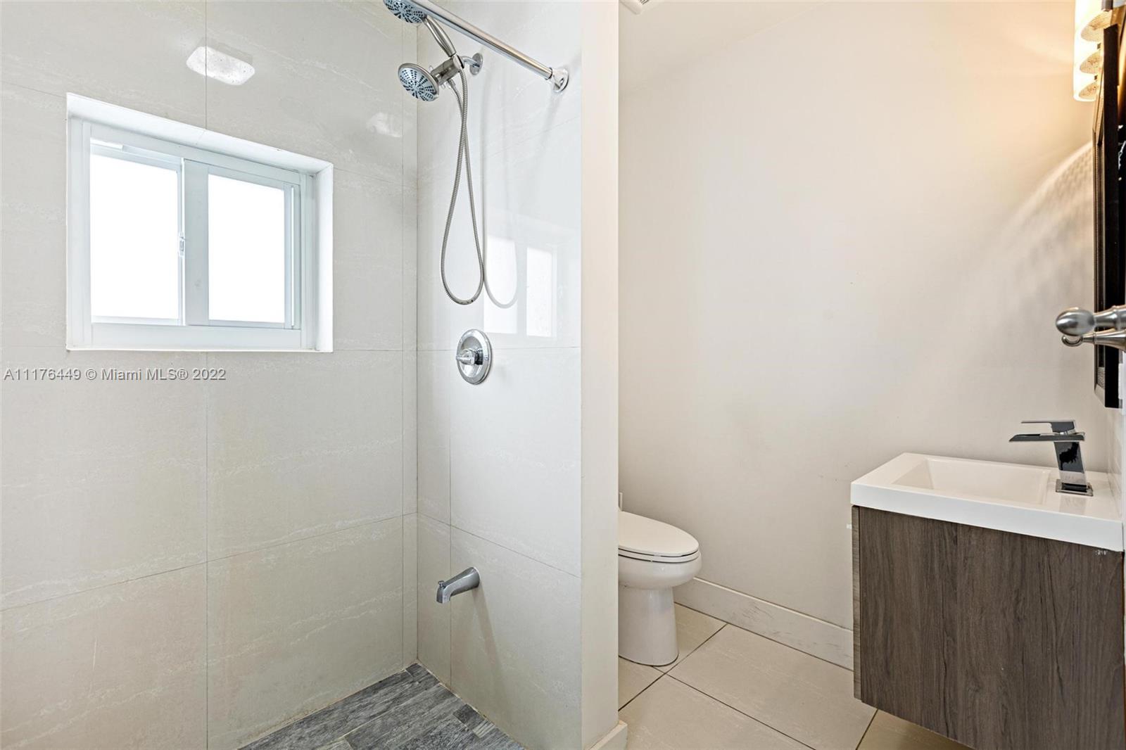 1910 Coral Gate Drive Miami, FL 33145 - Photo 29 of 39 a bathroom with a sink a toilet and shower