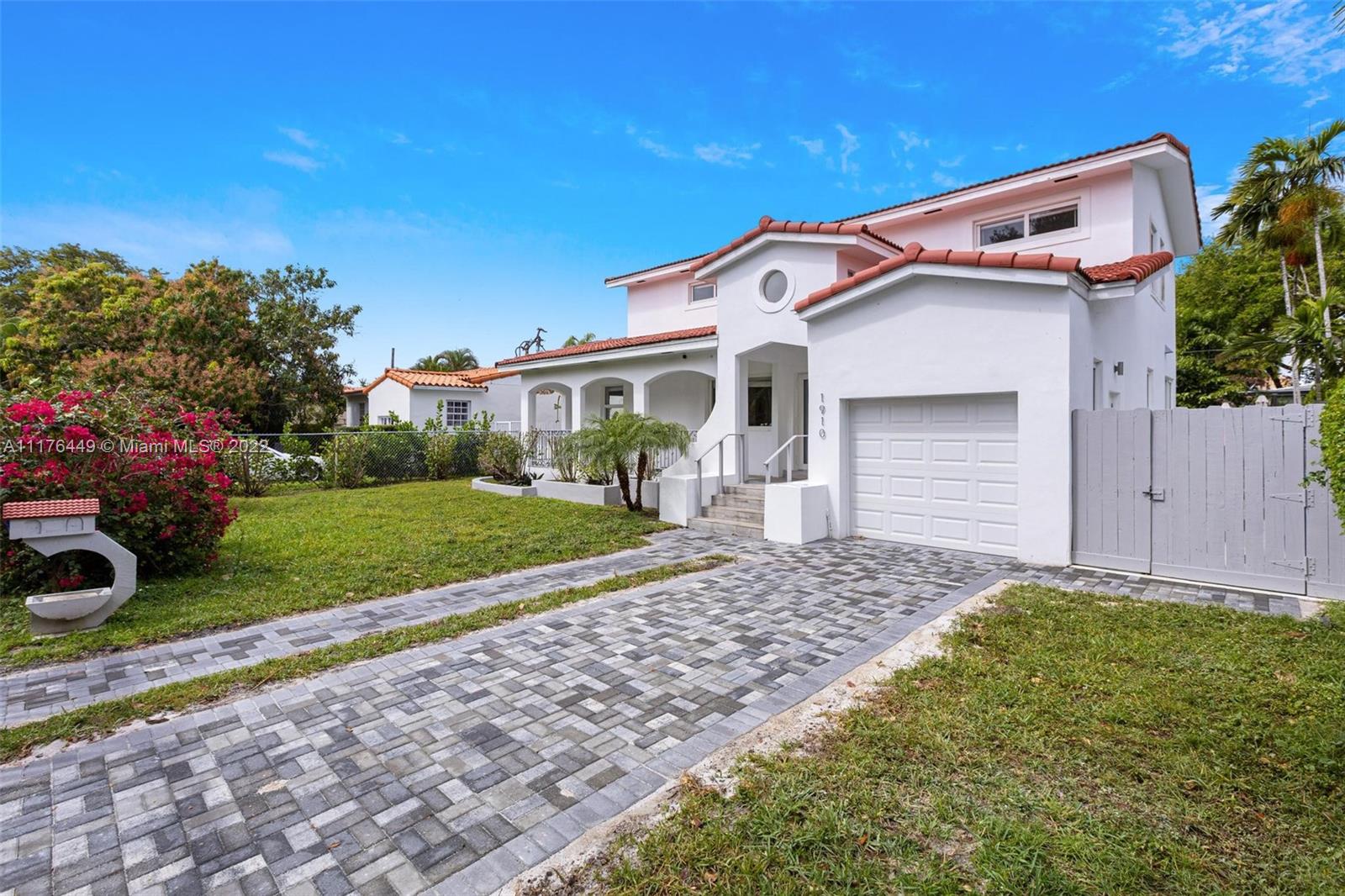1910 Coral Gate Drive Miami, FL 33145 - Photo 31 of 39 a front view of a house with a yard and garage