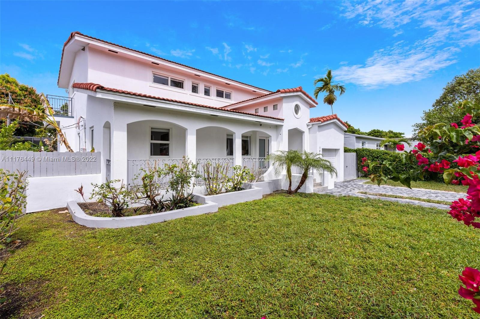 1910 Coral Gate Drive Miami, FL 33145 - Photo 32 of 39 a front view of a house with a garden and plants