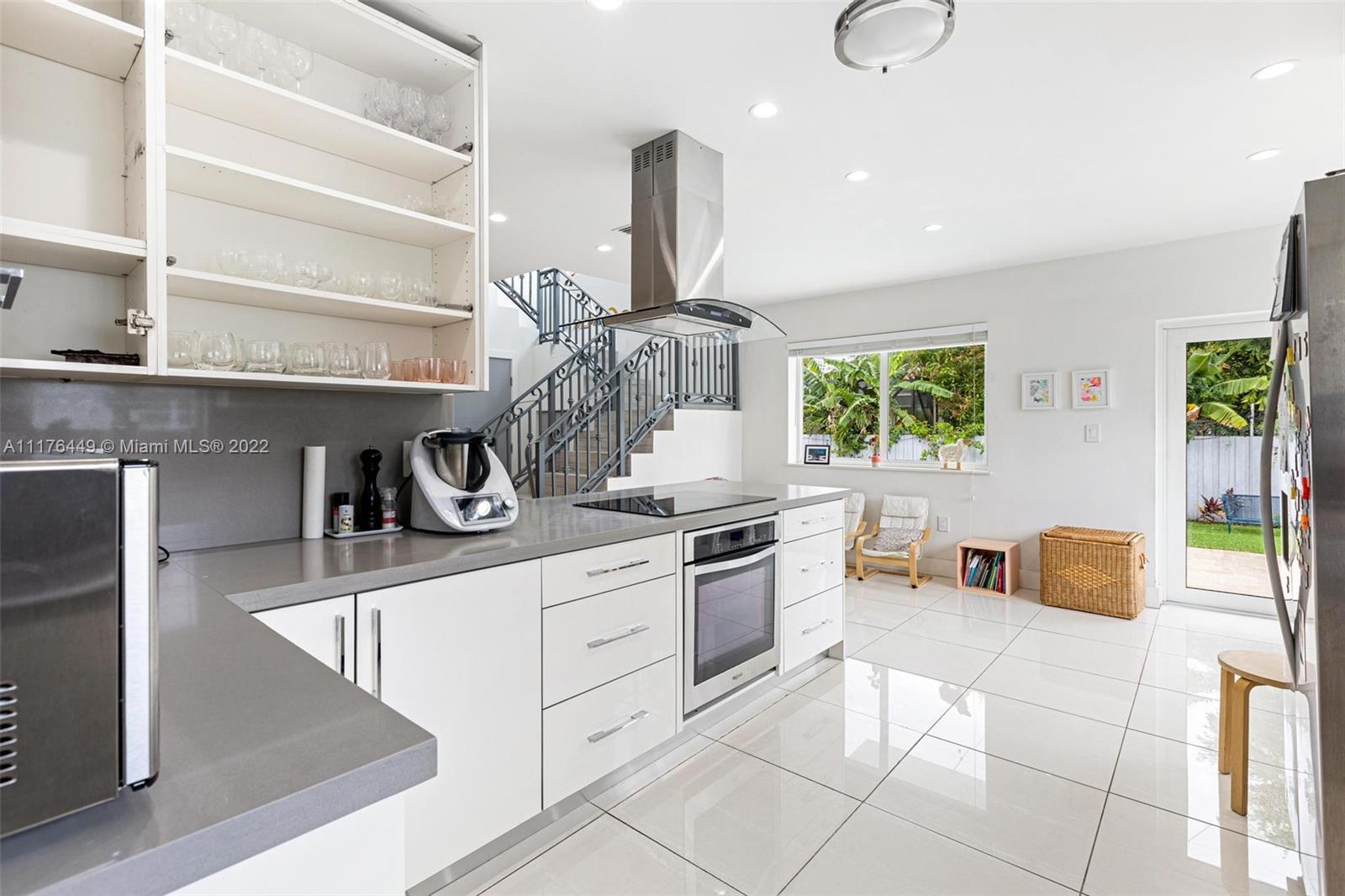 1910 Coral Gate Drive Miami, FL 33145 - Photo 10 of 39 a kitchen with stainless steel appliances granite countertop a sink and cabinets