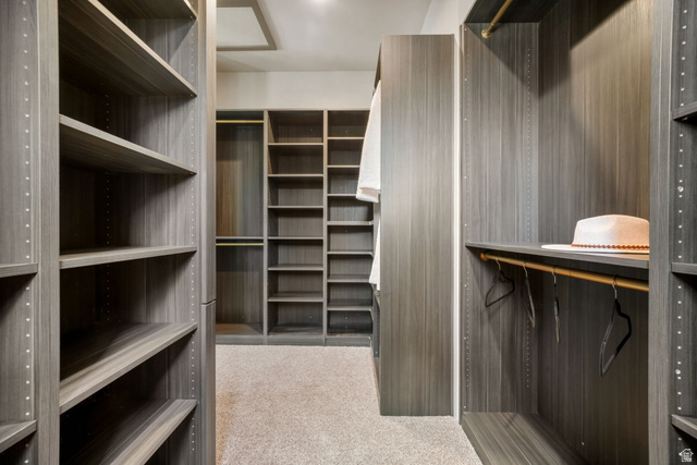 10646 North Reflection Ridge Hideout, UT 84036 - Photo 34 of 43 Custom closet system featuring wood-finish shelving, multiple hanging rods, and integrated storage solutions