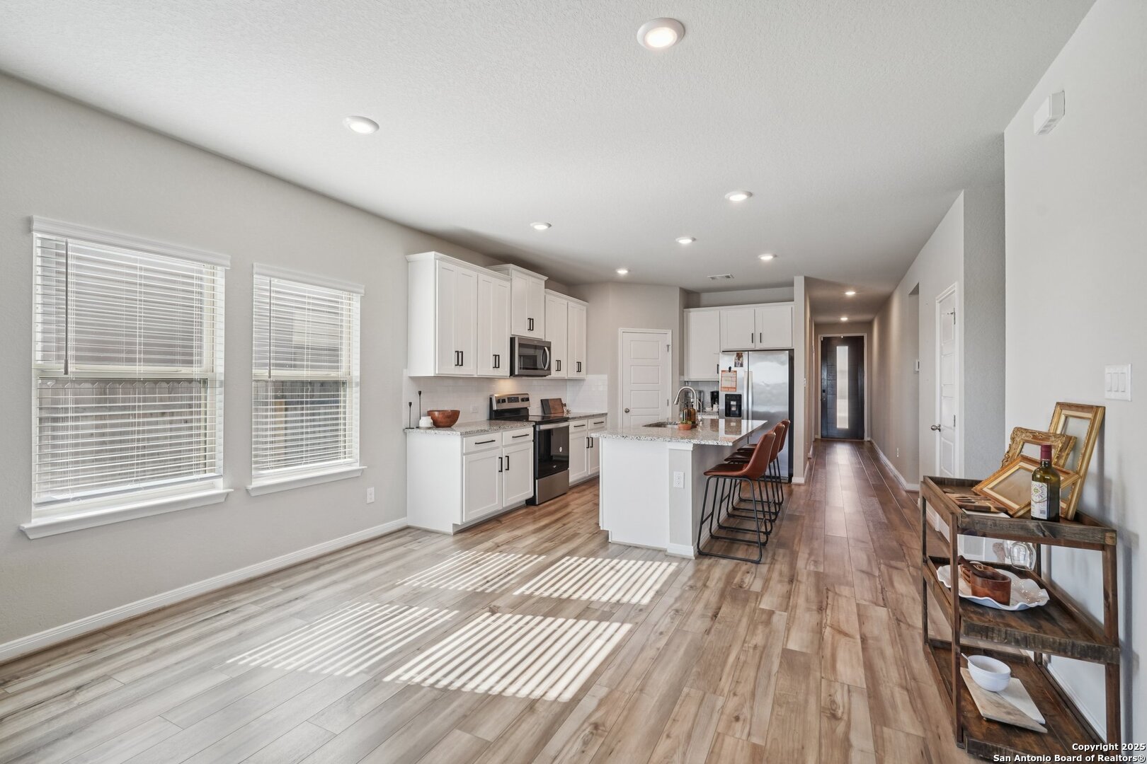 3311 Junction Bay Converse, TX 78109 - Photo 12 of 50 a large white kitchen with wooden floor and a window