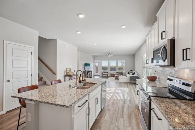 a kitchen with lots of counter top space and wooden floor
