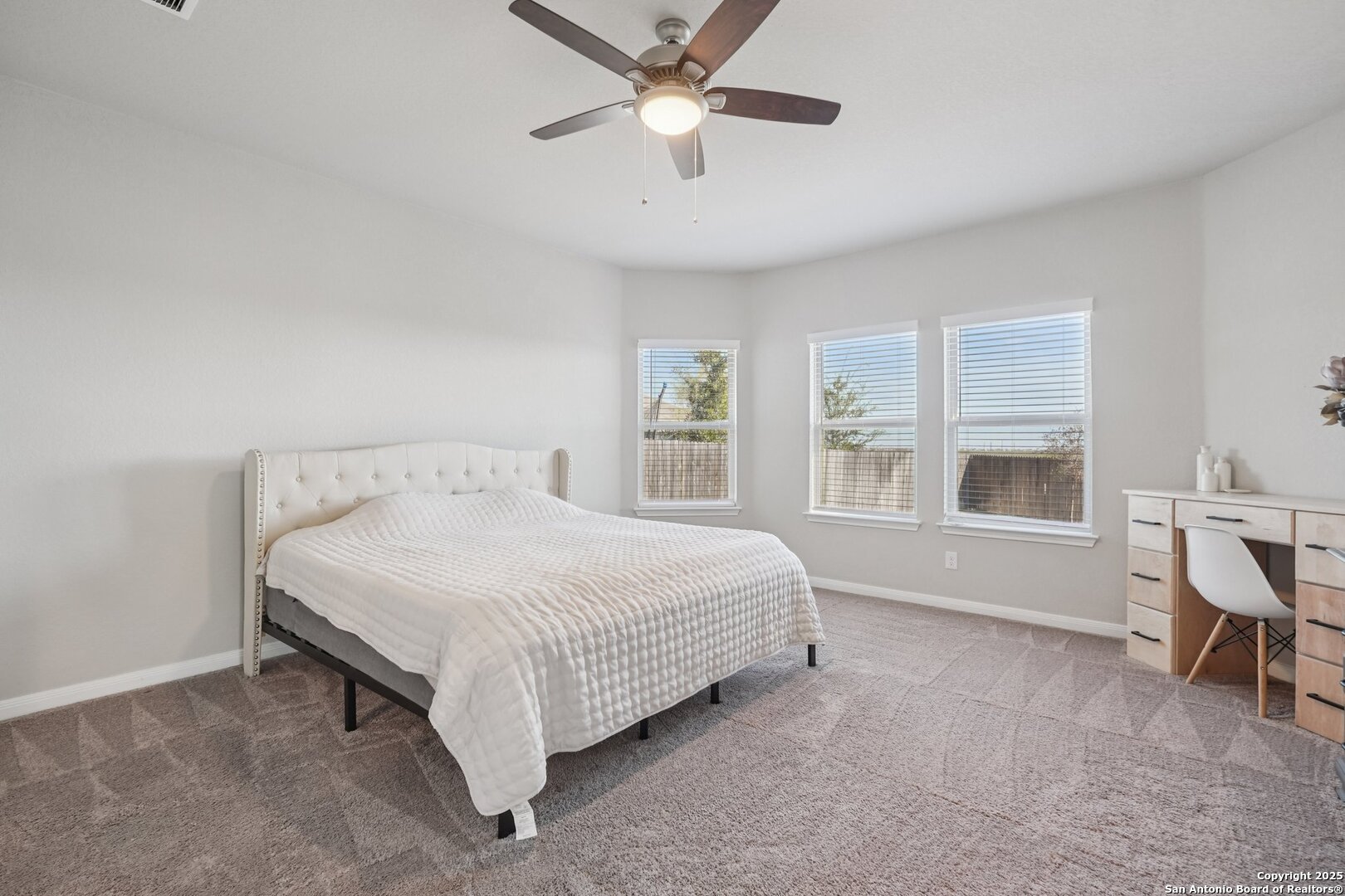 3311 Junction Bay Converse, TX 78109 - Photo 25 of 50 a spacious bedroom with a bed a chandelier and a window