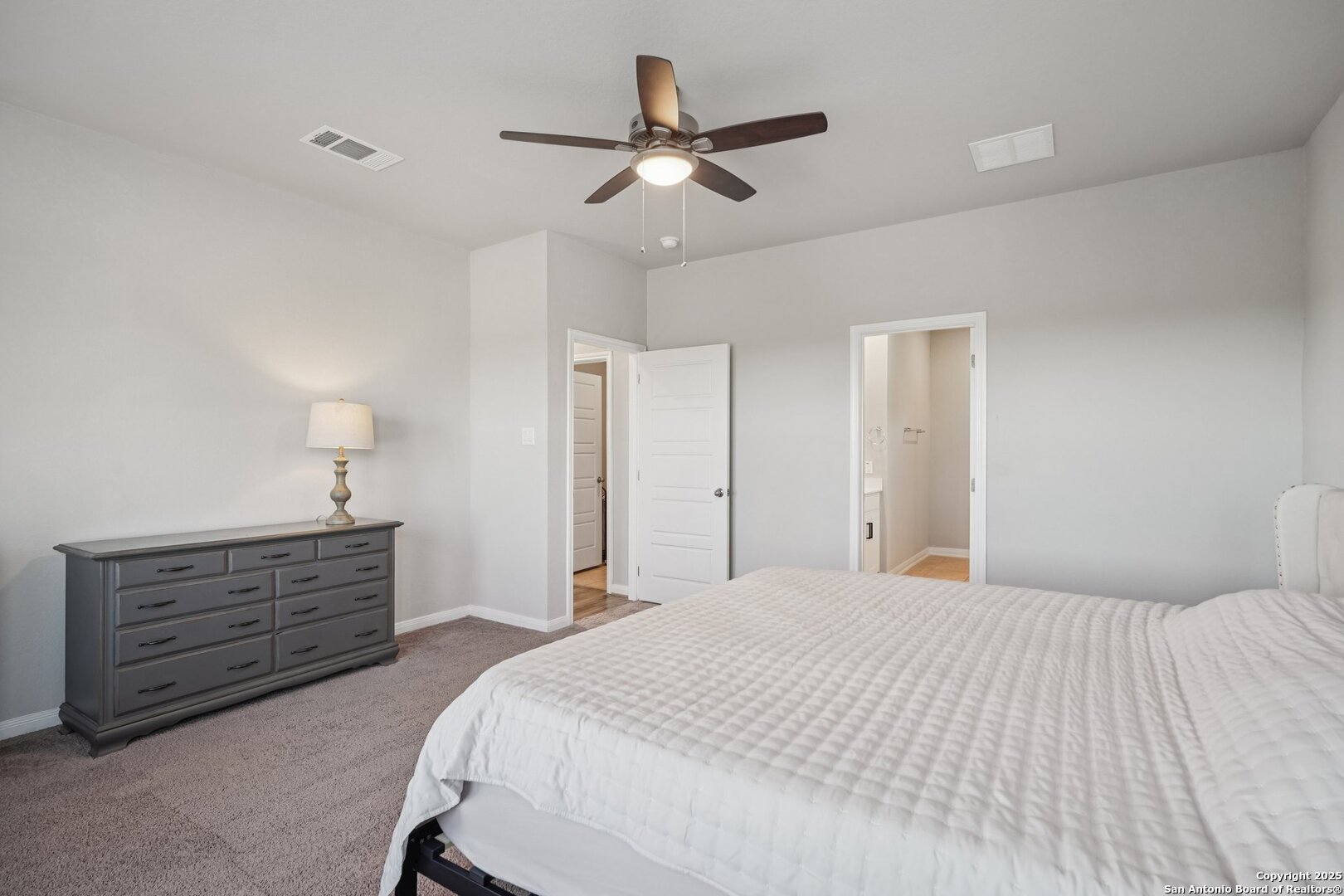 3311 Junction Bay Converse, TX 78109 - Photo 27 of 50 a bedroom with a bed chandelier and a dresser