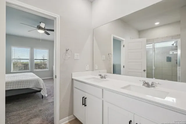 a en suite bathroom with a sink a mirror and a shower