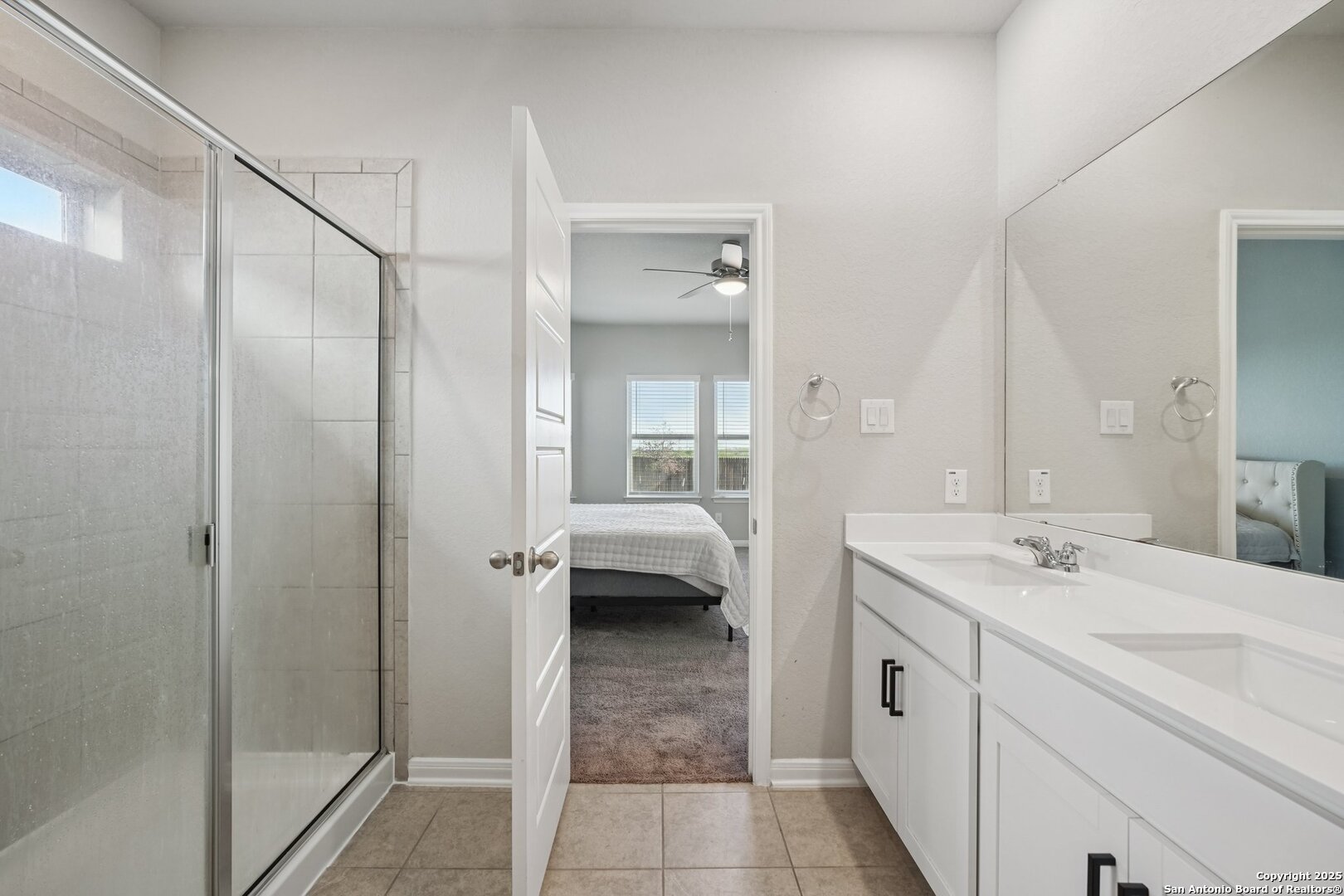 3311 Junction Bay Converse, TX 78109 - Photo 31 of 50 a en suite bathroom with a sink a mirror and a shower
