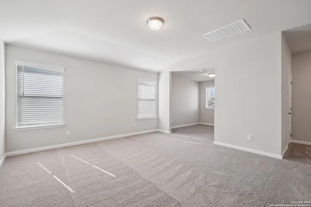 an empty room with windows and closet