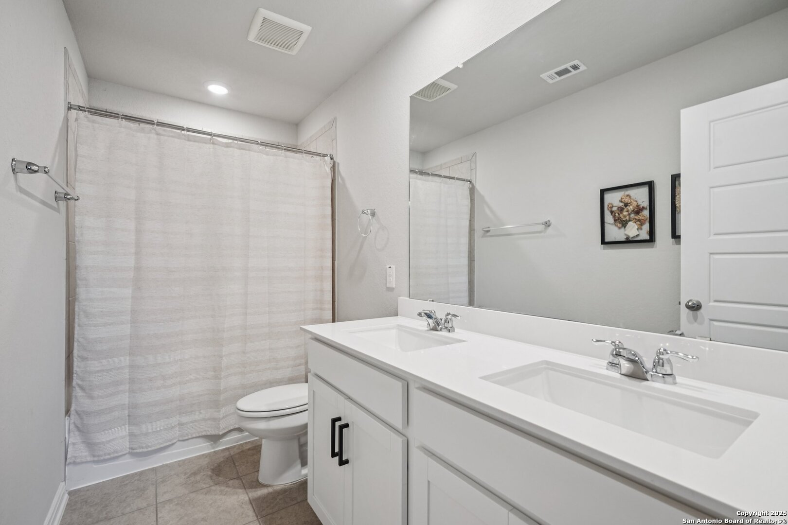 3311 Junction Bay Converse, TX 78109 - Photo 40 of 50 a bathroom with a double vanity sink toilet and a mirror