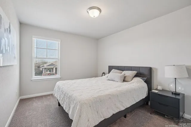 a bedroom with a bed and a lamp