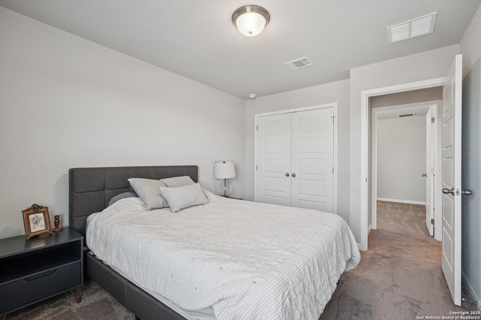 3311 Junction Bay Converse, TX 78109 - Photo 44 of 50 a bedroom with a bed and a lamp