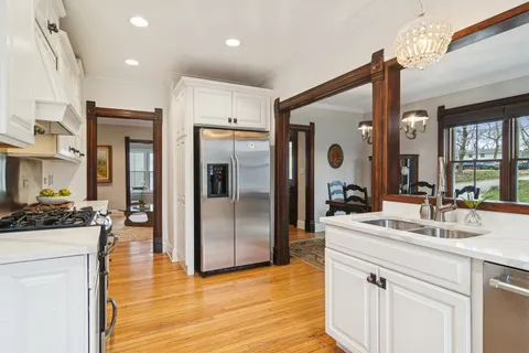 a kitchen with stainless steel appliances granite countertop a sink and a refrigerator